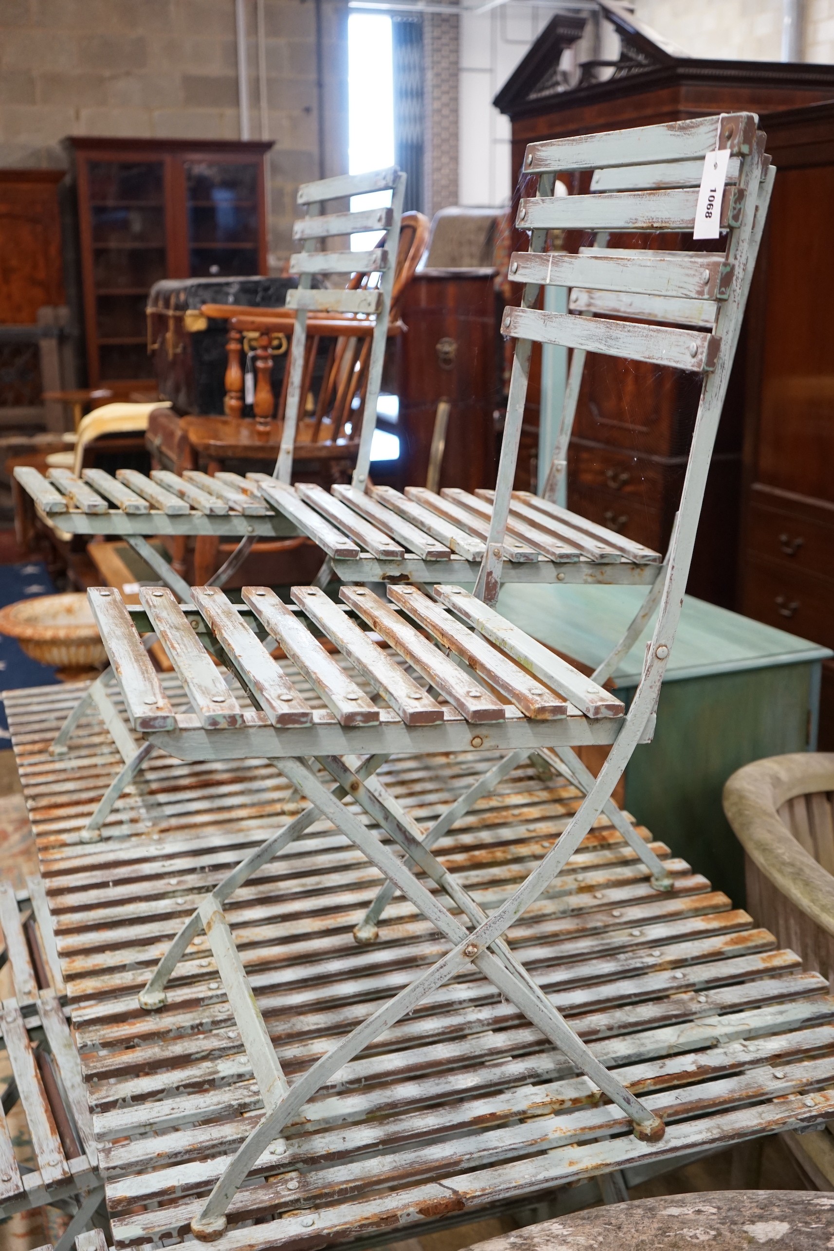 A pair of rectangular painted metal slatted garden tables, each width 86cm, depth 87cm, height 74cm and six matching folding chairs